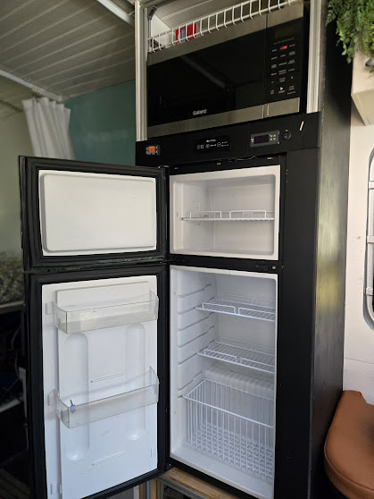 Refrigerator and appliance tower with fridge open